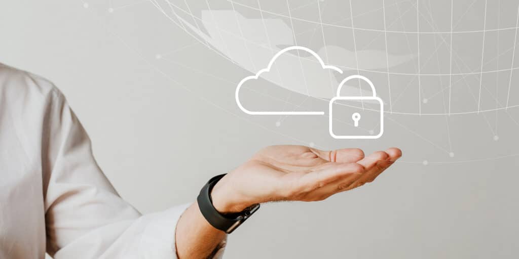 A hand holding a cloud and a padlock representing a protected cloud-based data system.